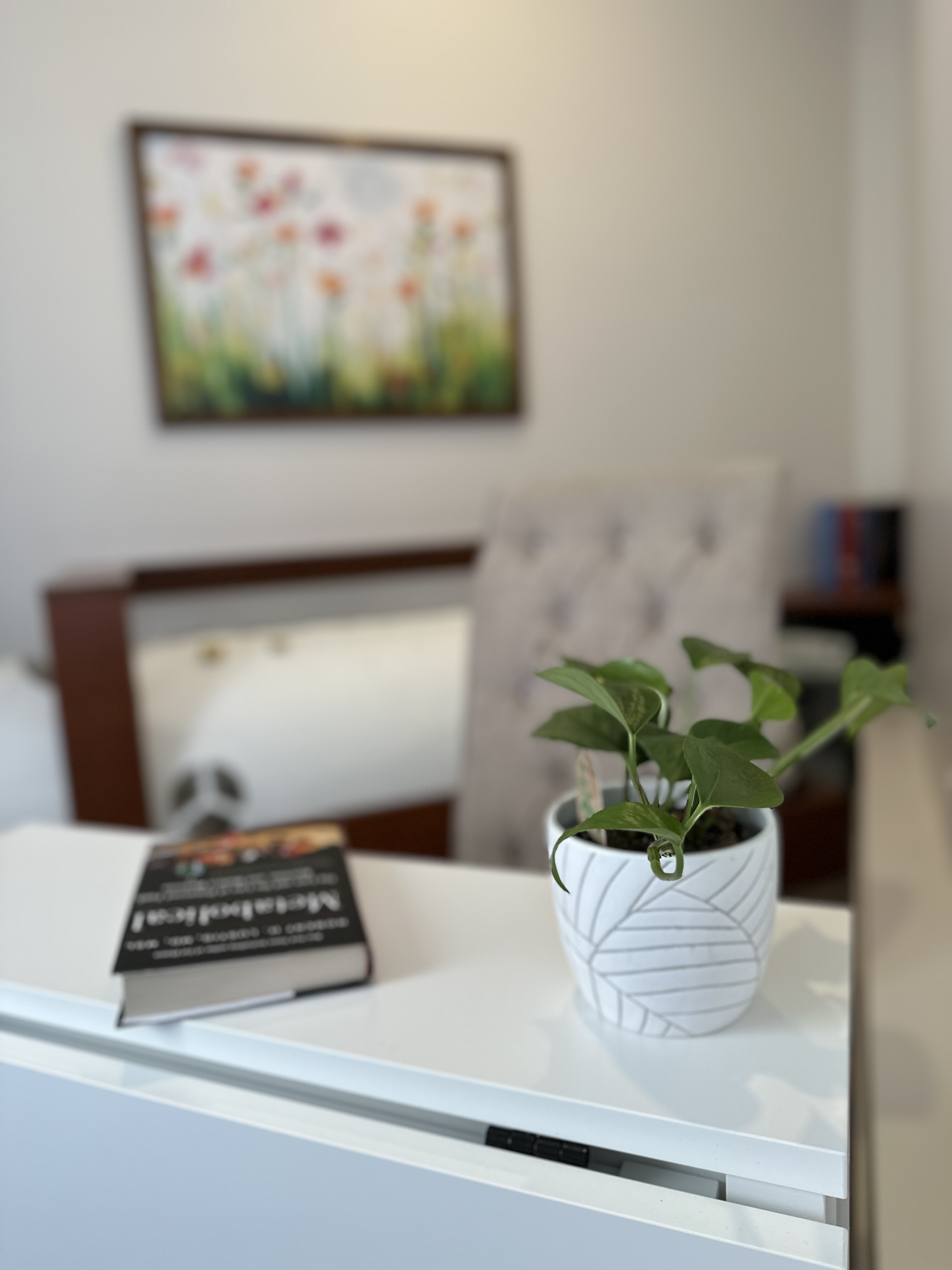 The chamber alongside a tall bookshelf of natural-health and herbal references — quiet, lived-in, considered.