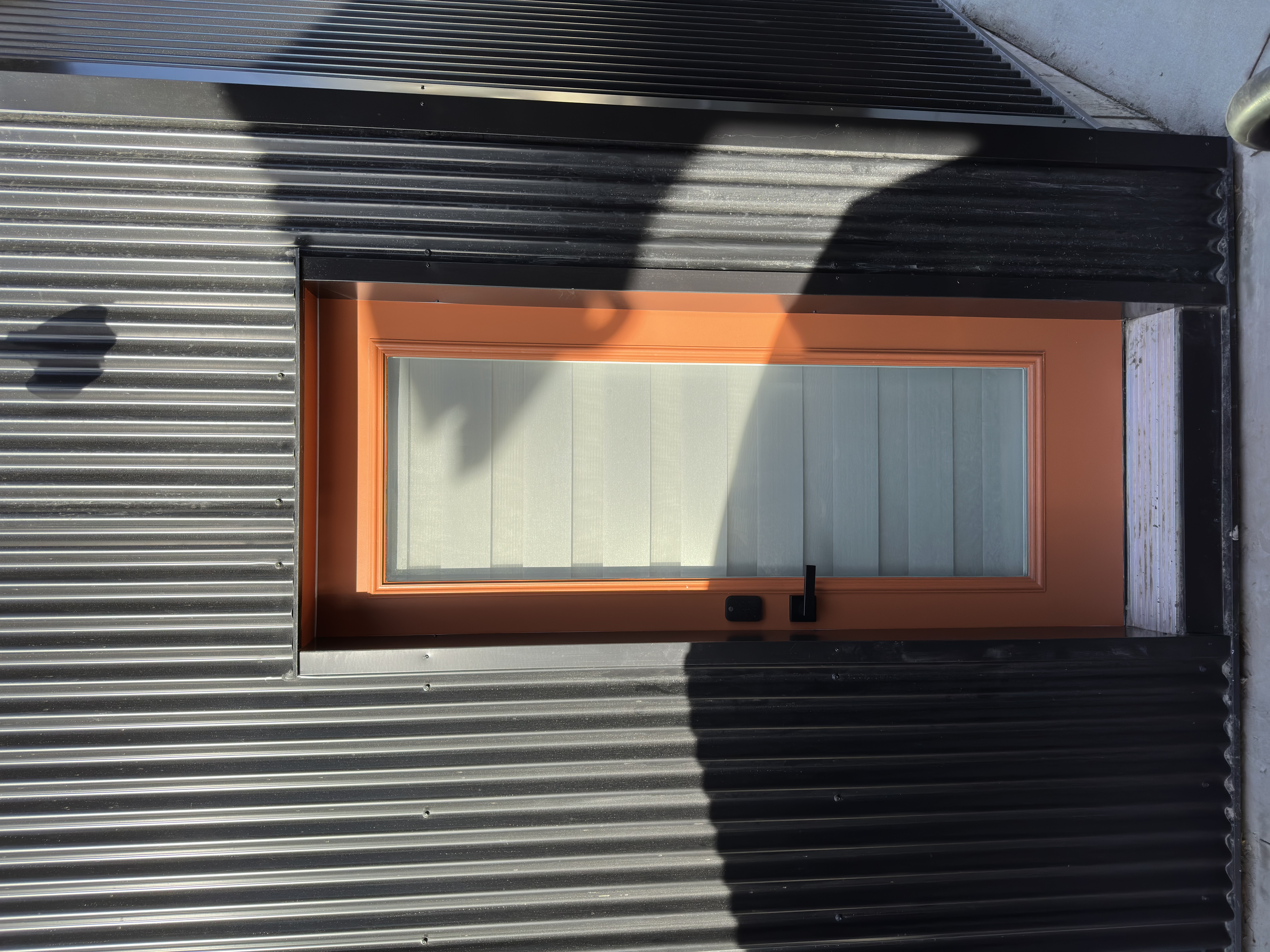 Close detail of the warm wood frame around the soft-shell chamber, showing the craftsmanship of the cabinetry.